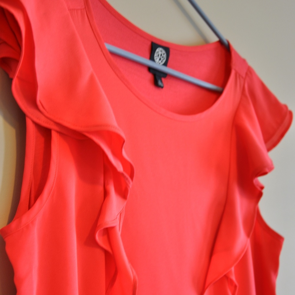 Bright pink top with flowy detail